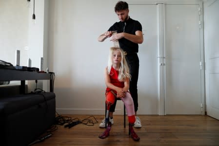 Model Daisy-May Demetre, 9 year-old double amputee who will walk the runway during Paris Fashion Week, gets her hair done a day before the luxury children's wear label Lulu et Gigi show in Paris