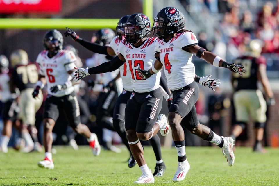 North Carolina State Wolfpack celebrate a play. The North Carolina State Wolfpack lead the Florida State Seminoles 14-0 at the half Saturday, Nov. 6, 2021.