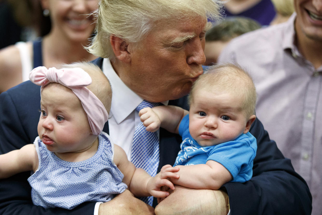 Then-GOP candidate Donald Trump kisses a baby during a campaign rally in July 2016 in Colorado Springs, Colo. (Photo: Evan Vucci/AP)