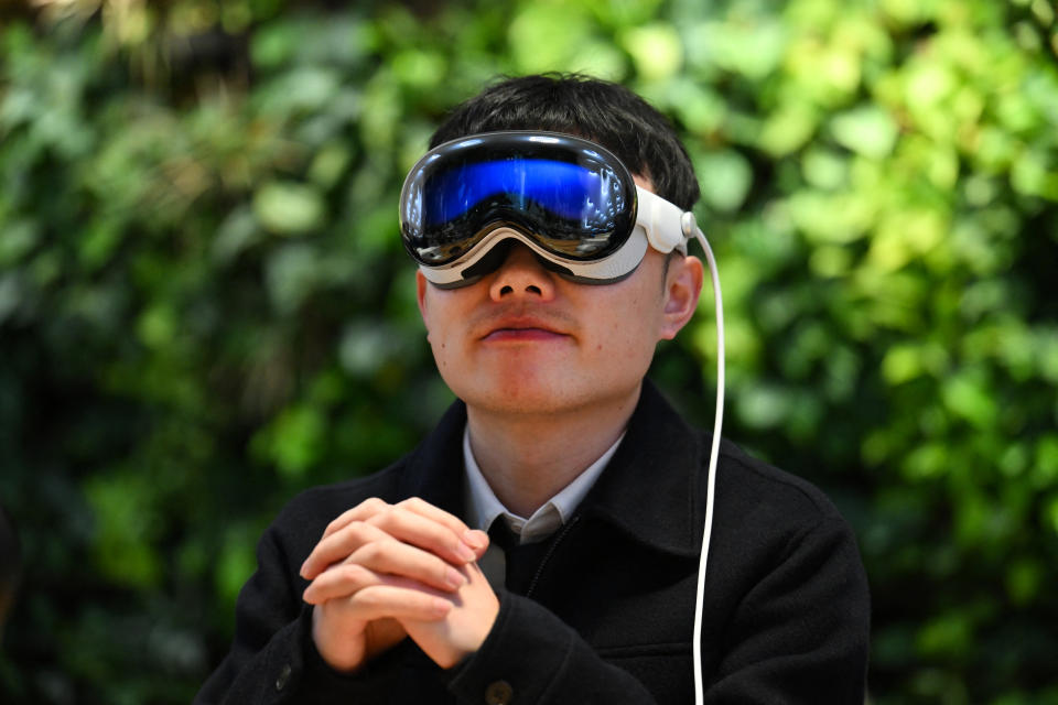 A customer tries on the Apple Vision Pro headset during the product launch at the Apple Store in New York City on February 2, 2024. The Vision Pro, the tech giant's $3,499 headset, is its first major release since the Apple Watch nine years ago. (Photo by ANGELA WEISS / AFP) (Photo by ANGELA WEISS/AFP via Getty Images)