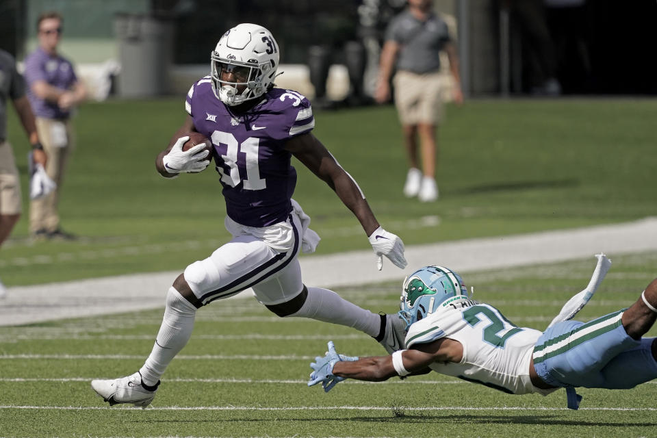 Kansas State running back DJ Giddens (31) gets past Tulane defensive back Jadon Canady (28) during the first half of an NCAA college football game Saturday, Sept. 17, 2022, in Manhattan, Kan. (AP Photo/Charlie Riedel)