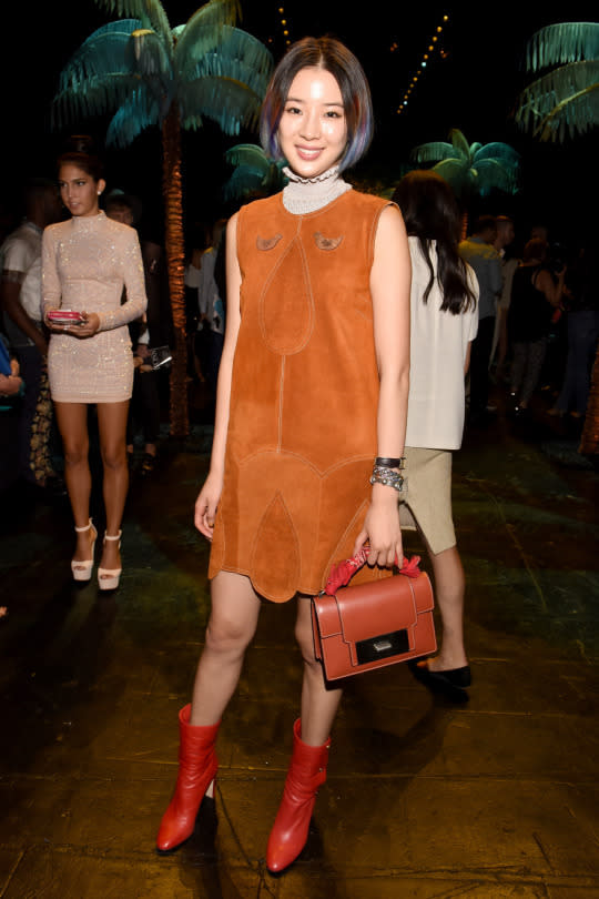 <p>The blogger opted for a ‘70s vibe in a suede brunt orange mini dress, orange calf-high boots and a matching mini bag.</p>