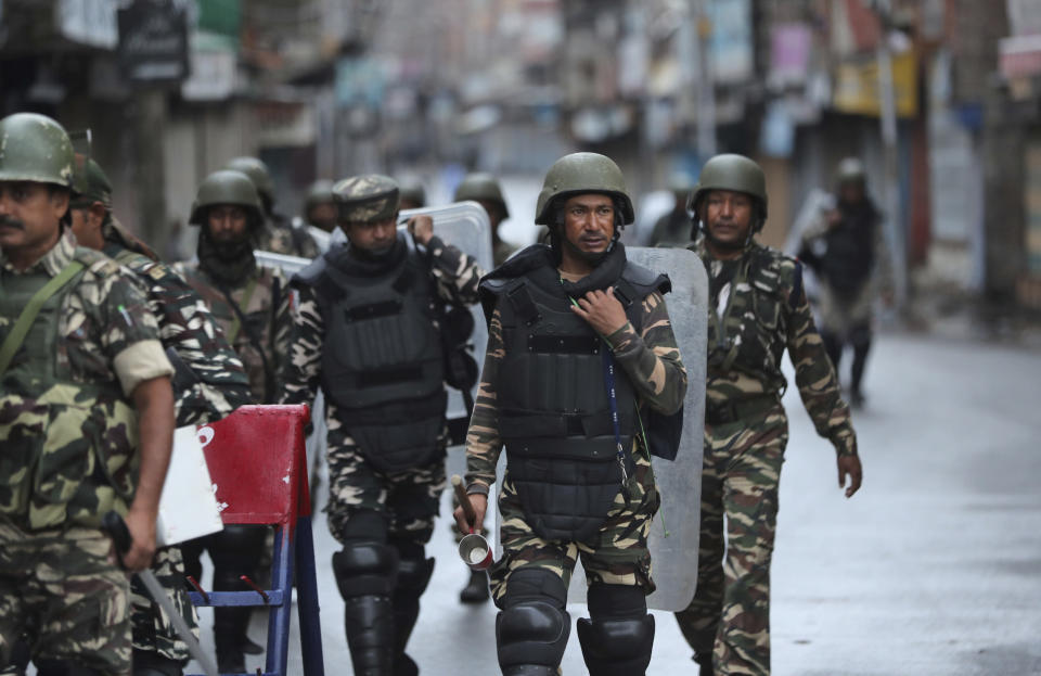 Indian paramilitary soldiers patrol a street in Srinagar, Indian controlled Kashmir, Saturday, Aug. 10, 2019. Authorities enforcing a strict curfew in Indian-administered Kashmir will bring in trucks of essential supplies for an Islamic festival next week, as the divided Himalayan region remained in a lockdown following India's decision to strip it of its constitutional autonomy. The indefinite 24-hour curfew was briefly eased on Friday for weekly Muslim prayers in some parts of Srinagar, the region's main city, but thousands of residents are still forced to stay indoors with shops and most health clinics closed. All communications and the internet remain cut off. (AP Photo/Mukhtar Khan)