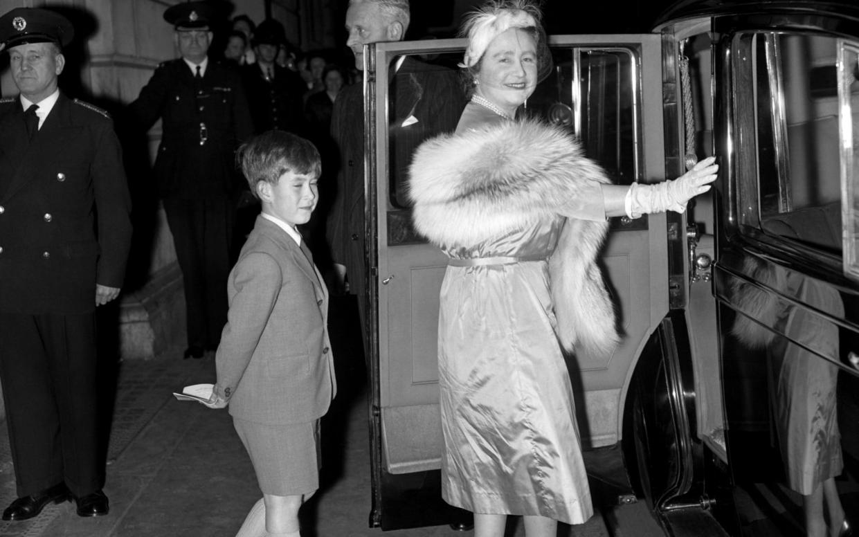 Prince Charles follows his grandmother, the Queen Mother, to their car after watching a matinee performance by the Bolshoi Theatre Ballet of Moscow at the Royal Opera House in October 1956 -  PA Archive