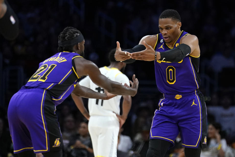 Los Angeles Lakers guard Russell Westbrook (0) and guard Patrick Beverley (21) celebrate after Westbrook scored during the first half of the team's NBA basketball game against the Utah Jazz on Friday, Nov. 4, 2022, in Los Angeles. (AP Photo/Marcio Jose Sanchez)