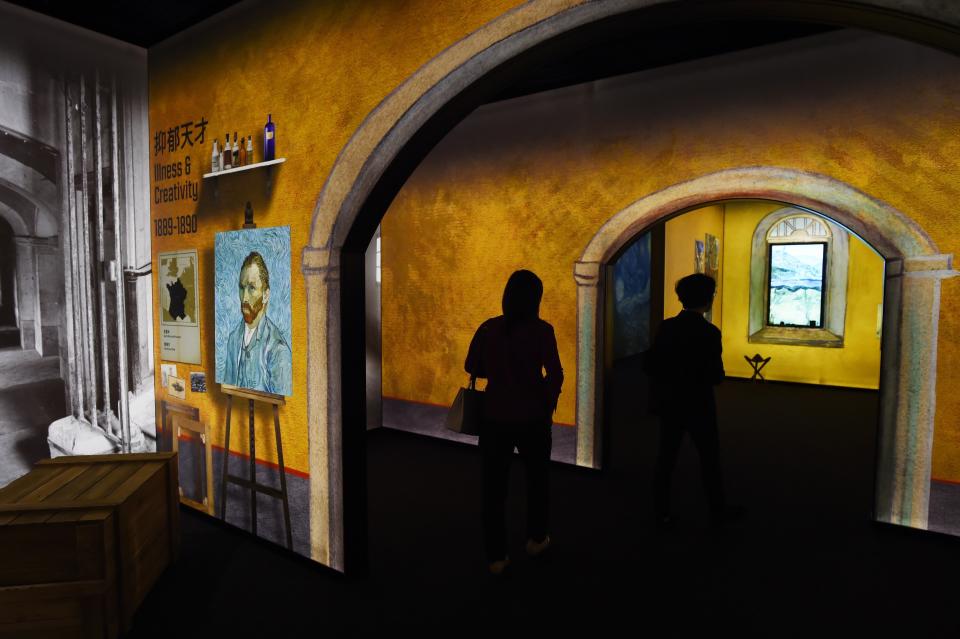 Visitors walk through an exhibition about the life and works of Dutch painter Vincent van Gogh, in Beijing on June 16, 2016. The exhibition, titled "Meet Vincent van Gogh," was created by the Van Gogh Museum and had its global launch in Beijing on June 15. Featuring reproductions of his work and recreations of scenes he painted, the exhibition is scheduled to tour cities across Greater China over the next five years.