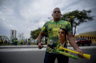 A supporter of Brazilian President Jair Bolsonaro waits for results after general election polls closed in Brasilia, Brazil, Sunday, Oct. 2, 2022. (AP Photo/Ton Molina)