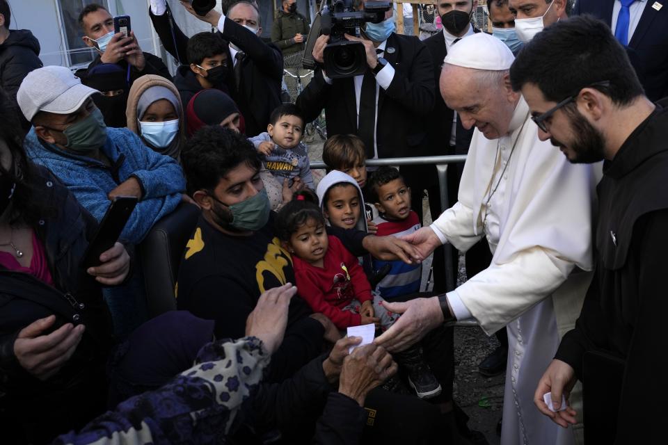 Pope Francis meets migrants during his visit at the Karatepe refugee camp, on the northeastern Aegean island of Lesbos, Greece, Dec. 5, 2021.Ten years after Pope Francis made a landmark visit to the Italian island of Lampedusa to show solidarity with migrants, he is joining Catholic bishops from around the Mediterranean this weekend in France to make the call more united, precisely at the moment that European leaders are again scrambling to stem the tide of would-be refugees setting off from Africa. (AP Photo/Alessandra Tarantino, file)