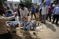 A passenger injured in a bus accident in Jammu and Kashmir's Poonch district is brought for treatment at a hospital in Jammu, India, Wednesday, Sept.14, 2022. Nearly a dozen people died and more people were injured when a mini-bus plunged into a deep gorge Wednesday. (AP Photo/Channi Anand)