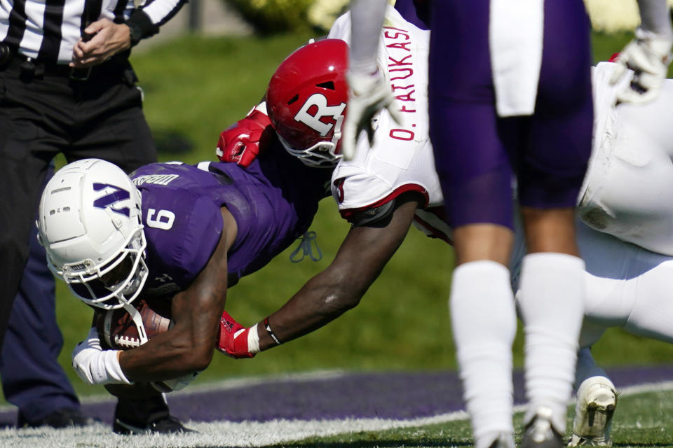 Northwestern wide receiver Malik Washington, left, is tackled by Rutgers linebacker Olakunle Fatukasi during the first half of an NCAA college football game in Evanston, Ill., Saturday, Oct. 16, 2021. (AP Photo/Nam Y. Huh)