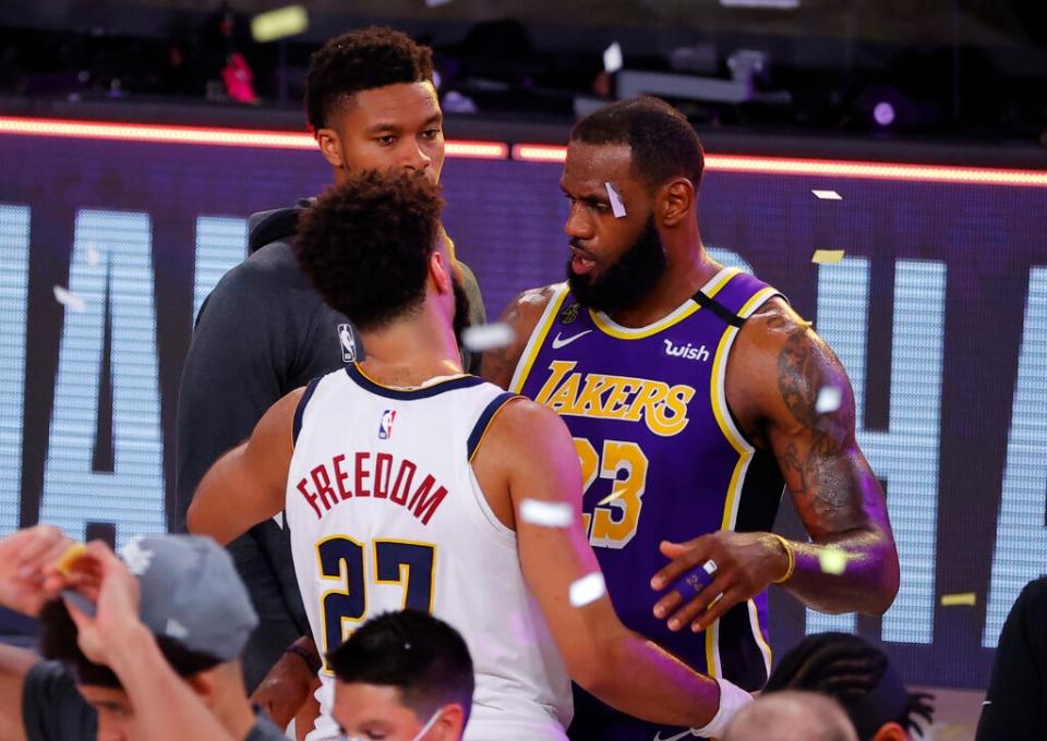 LeBron James #23 of the Los Angeles Lakers hugs Jamal Murray #27 of the Denver Nuggets after their win in Game Five of the Western Conference Finals during the 2020 NBA Playoffs at AdventHealth Arena at the ESPN Wide World Of Sports Complex on September 26, 2020 in Lake Buena Vista, Florida. (Photo by Kevin C. Cox/Getty Images)