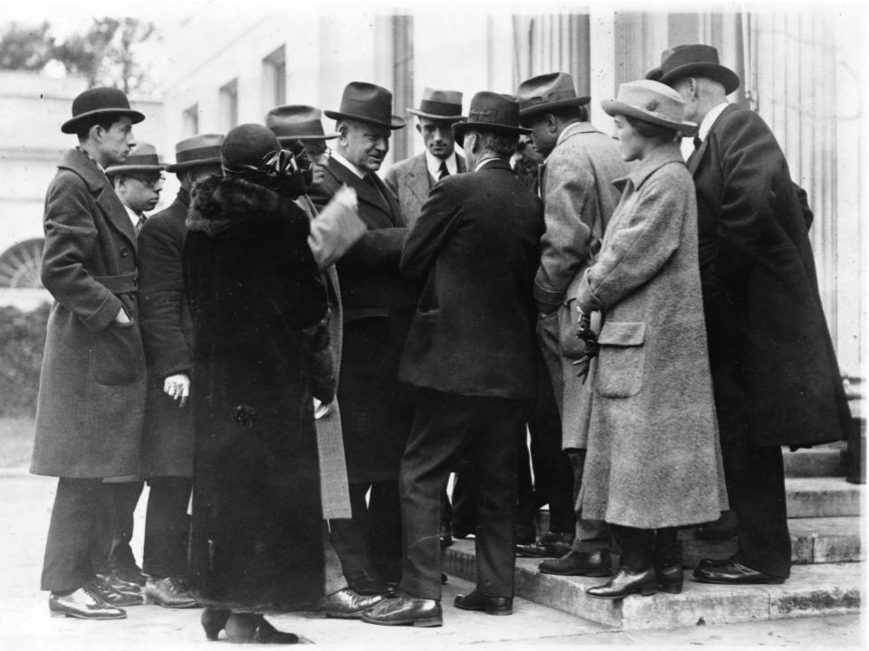 A media scrum surround then-Secretary of the Navy Edwin Denby amid the Teapot Dome scandal.