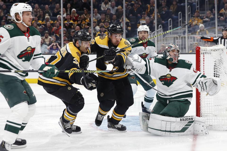 <p>
              Boston Bruins' Patrice Bergeron (37) and Brad Marchand (63) chase a deflection off Minnesota Wild goalie Alex Stalock (32) during the first period of an NHL hockey game in Boston, Saturday, Nov. 23, 2019. (AP Photo/Michael Dwyer)
            </p>