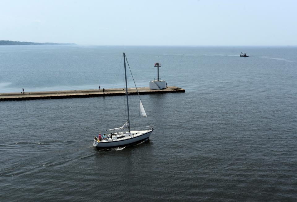 A sailboat cruises out of the St. Joseph River and into Lake Michigan Tuesday, May 23, 2023, in St. Joseph, Mich.