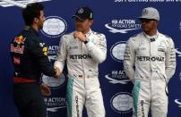 (L-R) Red Bull Racing driver Daniel Ricciardo, wotj Mercedes drivers Nico Rosberg and Lewis Hamilton, after the qualifying session of the German Grand Prix at the Hockenheim circuit on July 30, 2016