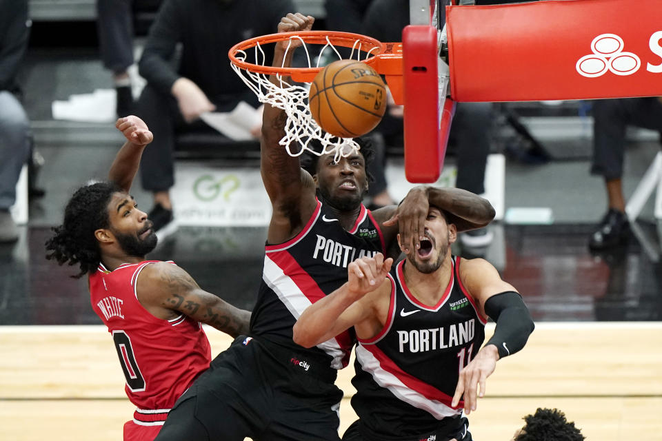 Portland Trail Blazers forward Nassir Little, center, shoots next to center Enes Kanter, right, and Chicago Bulls guard Coby White during the second half of an NBA basketball game in Chicago, Saturday, Jan. 30, 2021. (AP Photo/Nam Y. Huh)