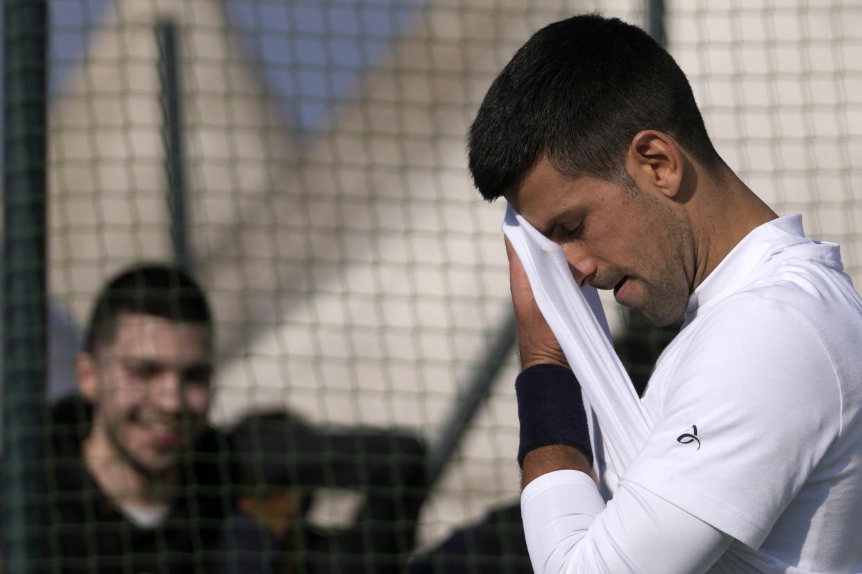 Serbian tennis player Novak Djokovic wipes his face during his open practise session in Belgrade, Serbia, Wednesday, Feb. 22, 2023. Djokovic said Wednesday he still hopes US border authorities would allow him entry to take part in two ATP Masters tennis tournaments despite being unvaccinated against the coronavirus. (AP Photo/Darko Vojinovic)