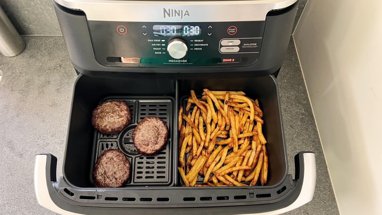  Ninja Foodi DualZone FlexBasket cooking burgers and fries. 