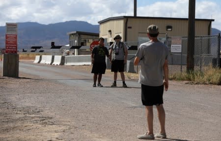 People take photos at the entrance to Area 51 as an influx of tourists responding to a call to 'storm' Area 51, a secretive U.S. military base believed by UFO enthusiasts to hold government secrets about extra-terrestrials, is expected in Rachel