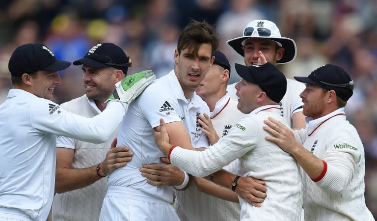 Steven Finn (3rd left) is congratulated after taking the wicket of Steven Smith (not pictured) for 7 runs on the first day of the third Ashes test at Edgbaston on July 29, 2015