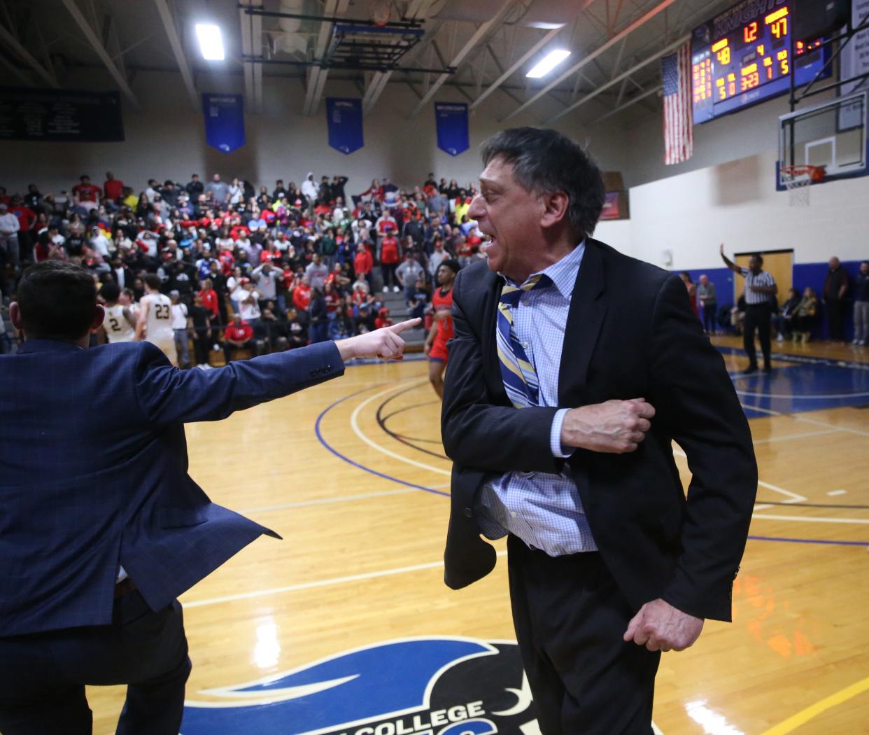 Our Lady of Lourdes boys basketball head coach Jim Santoro cheers after Thomas Simpson hit the winning 3-pointer against Peekskill in the Class AA regional final on March 8, 2024.