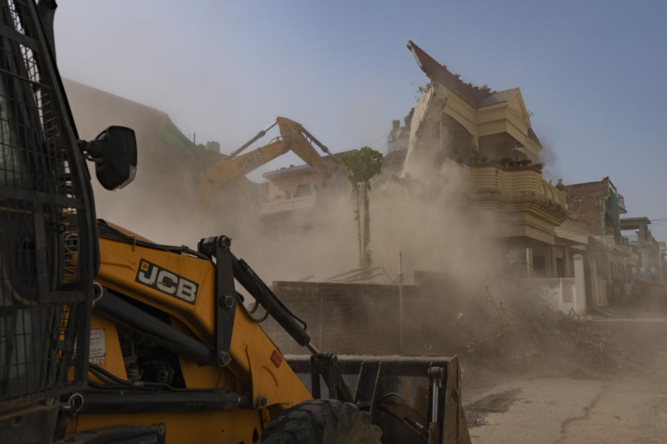 FILE - Authorities demolish the residence of activist Javed Ahmad they say has been constructed illegally in Prayagraj, India June 12, 2022. Protests have been erupting in many Indian cities to condemn the demolition of homes and businesses belonging to Muslims, in what critics call a growing pattern of "bulldozer justice" aimed at punishing activists from the minority group. As India, the world’s largest democracy, celebrates 75 years of independence on Aug. 15, its independent judiciary, diverse media and minorities are buckling under the strain, putting its democracy under pressure. (AP Photo/Rajesh Kumar Singh, File)