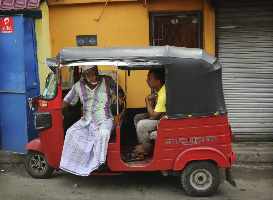 Sri Lankan Muslims talk sitting inside a three-wheeler in Colombo, Sri Lanka, Monday, April 29, 2019. The Catholic Church in Sri Lanka said Monday that the government should crack down on Islamic extremists with more vigor "as if on war footing" in the aftermath of the Easter bombings. Meanwhile, the government has banned all kinds of face coverings that may conceal people's identities. The emergency law, which took effect Monday, prevents Muslim women from veiling their faces. (AP Photo/Manish Swarup)