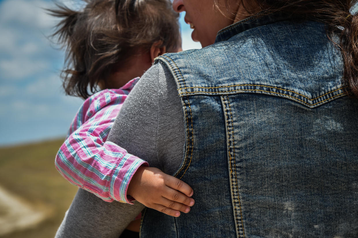 MCALLEN, TX - JUNE 29: Karina Lopez, a 23-year-old single mother from Guatemala carries her one-year-old daughter in her arms are being detained by Border Patrol after crossing illegally into the United States on Thursday, June 29, 2017 (Photo: The Washington Post via Getty Images)