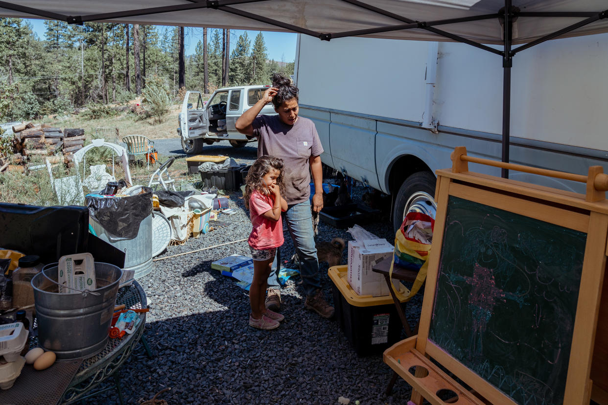 Salinas and her daughter River outside their temporary trailer home. (Andri Tambunan for NBC News)