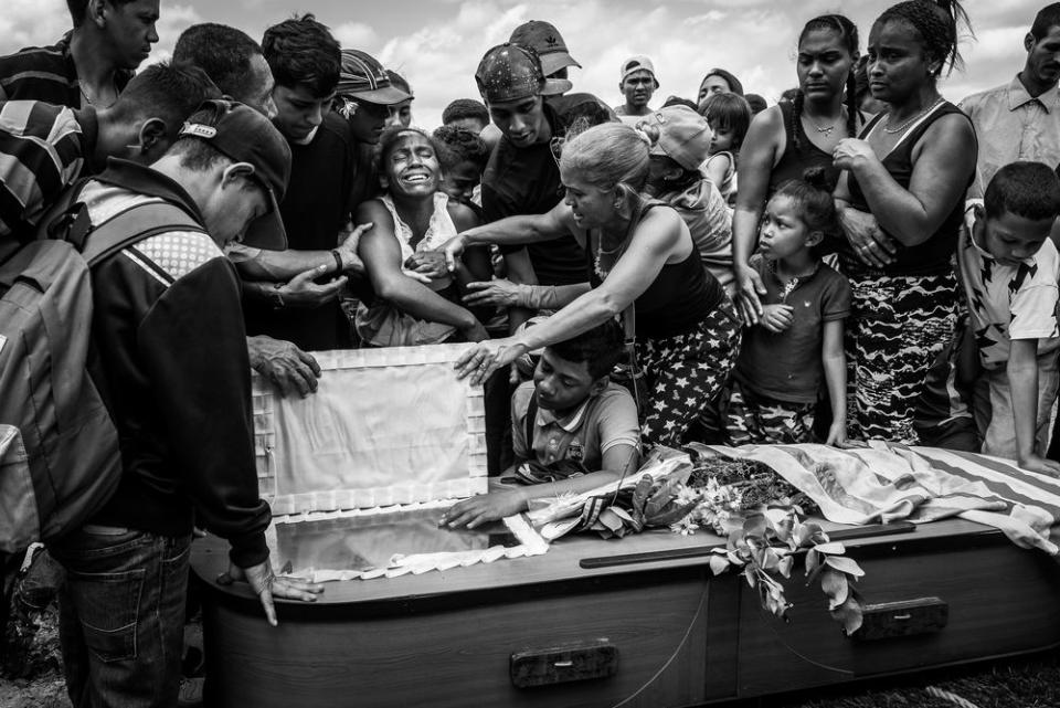 A woman cries during the funeral of her husband Keiber Cubero, 25, who was allegedly executed by police after he was caught robbing a restaurant, in search of food.