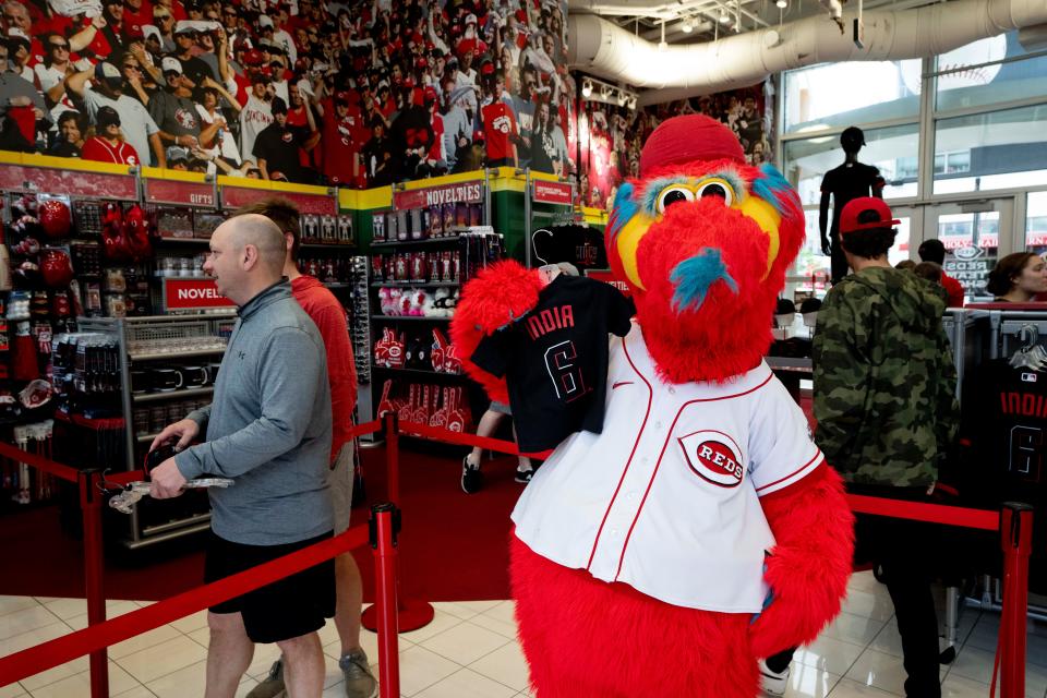 Gapper holds up a a Nike Reds City Connect jersey on sale at the Reds Team Shop at Great American Ball Park in Cincinnati on Saturday, May 13, 2023. 