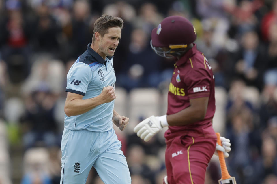 England's Chris Woakes celebrates taking the wicket of West Indies' Evin Lewis, right, during the Cricket World Cup match between England and West Indies at the Hampshire Bowl in Southampton, England, Friday, June 14, 2019. (AP Photo/Matt Dunham)