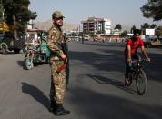 An Afghan policeman stands guard at a check point in Kabul, Afghanistan