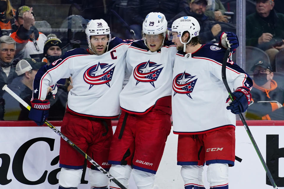 Columbus Blue Jackets' Boone Jenner, from left, Patrik Laine and Andrew Peeke celebrate after Laine's goal during the third period of an NHL hockey game against the Philadelphia Flyers, Thursday, Jan. 20, 2022, in Philadelphia. (AP Photo/Matt Slocum)