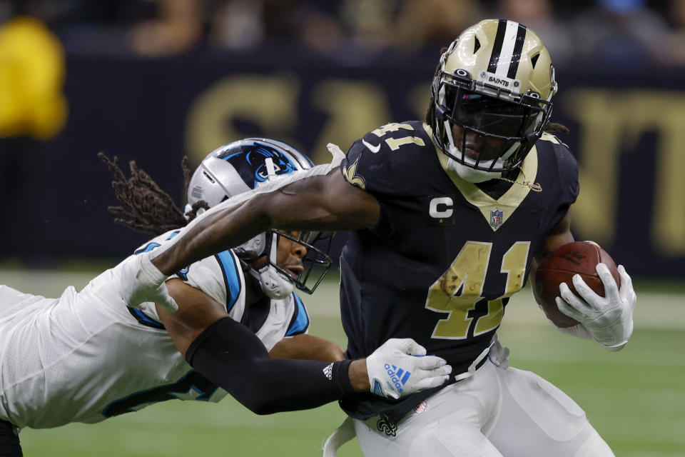 New Orleans Saints running back Alvin Kamara is tackled by Carolina Panthers cornerback Josh Norman during the second half an NFL football game between the Carolina Panthers and the New Orleans Saints in New Orleans, Sunday, Jan. 8, 2023. (AP Photo/Butch Dill)