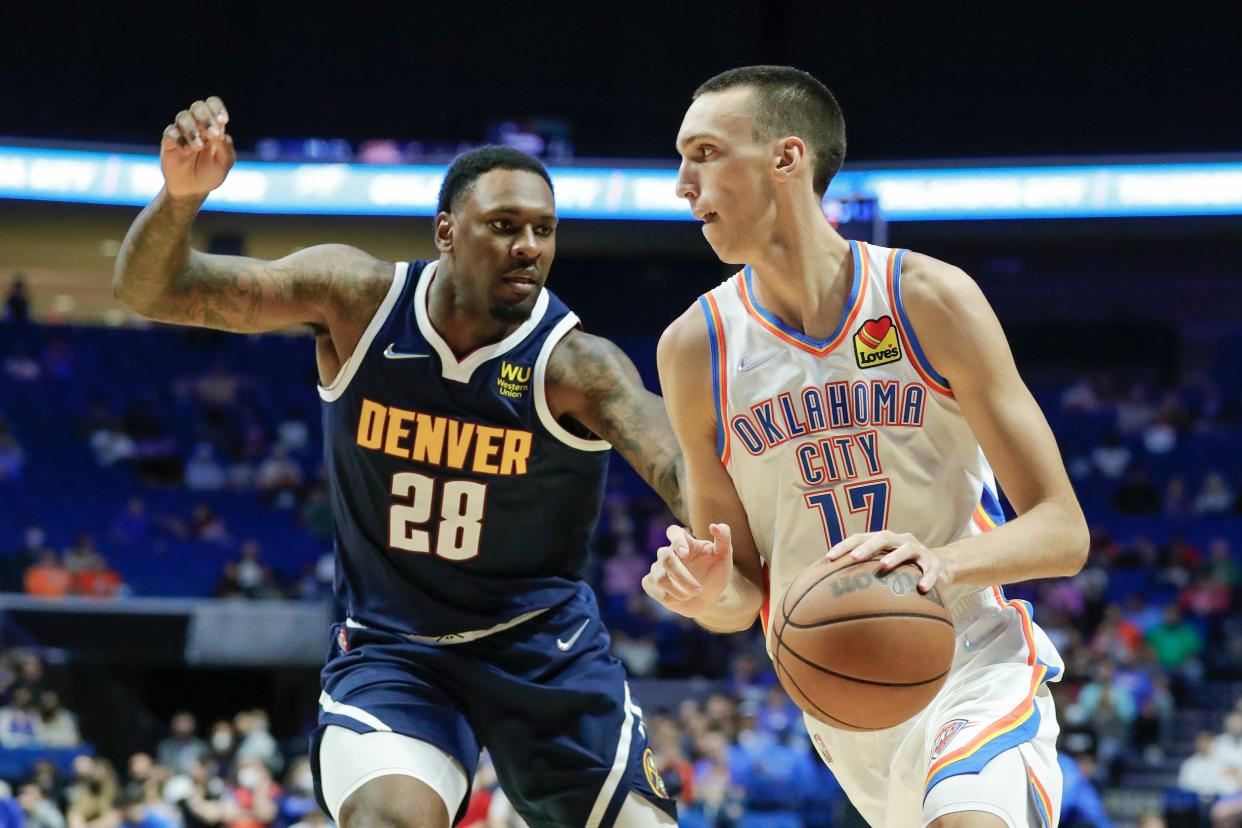 Thunder forward Aleksej Pokusevski (17) drives to the basket around Nuggets forward Tarik Black (28) during the second half at BOK Center in Tulsa on Thursday. Denver won 113-107 in overtime.