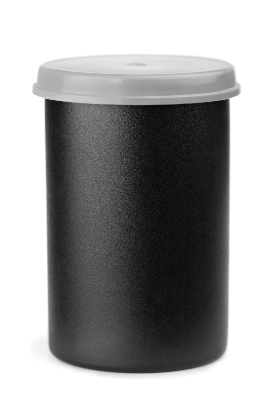 Black cylindrical container with a white lid, isolated on white background