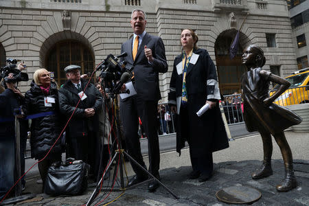 New York City Mayor Bill de Blasio speaks while Manhattan Borough president Gale Brewer looks on next to the "Fearless Girl" statue in New York, U.S., March 27, 2017. REUTERS/Shannon Stapleton