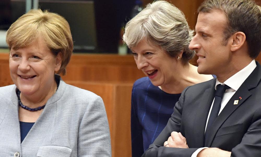 Theresa May speaks with French president Emmanuel Macron and German chancellor Angela Merkel.