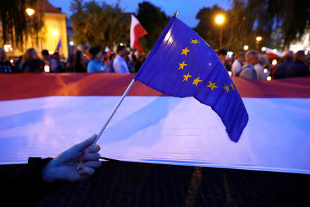 People gather next to the Supreme Court during the "Chain of the lights" candlelit protest against judicial reforms in Warsaw, Poland July 25, 2017. REUTERS/Kacper Pempel