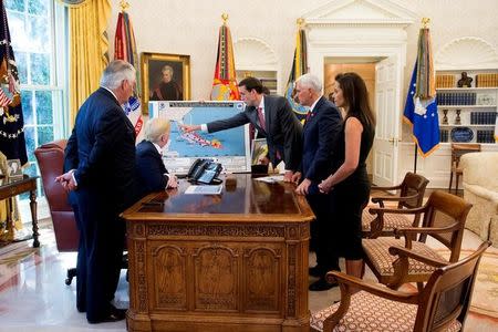 U.S. President Donald Trump is seen in an official White House handout photo with U.S. Secretary of State Rex Tillerson (L), Homeland Security and Counterterrorism Adviser Thomas Bossert (3rdR), Vice President Mike Pence (2ndR) and Deputy National Security Adviser Dina Powell (R) as he participates in an Oval Office briefing tracking the approach of Hurricane Irma toward the coast of Florida, at the White House in Washington, U.S., September 7, 2017. Andrea Hanks/Courtesy of the White House/Handout via REUTERS