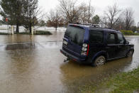 A car sits semi-submerged in flood waters at Camden on the outskirts of Sydney, Australia, Monday, July 4, 2022. More than 30,000 residents of Sydney and its surrounds have been told to evacuate or prepare to abandon their homes on Monday as Australia’s largest city braces for what could be its worst flooding in 18 months. (AP Photo/Mark Baker)