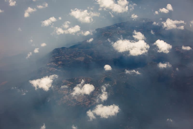 Smoke and haze over mountains are seen from a No 11 Squadron P-8A Poseidon conducting damage assessment and surveillance in the bushfire-affected area near Cooma