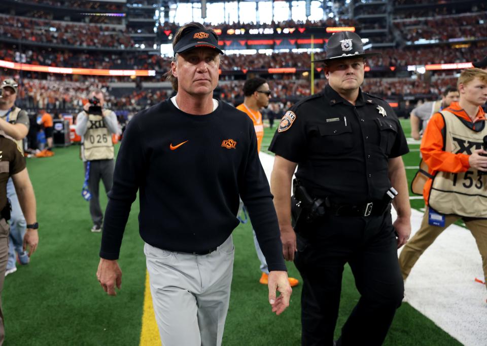 Oklahoma State football head coach Mike Gundy walks of the field following the Big 12 Football Championship game between the Oklahoma State University Cowboys and the Texas Longhorns at the AT&T Stadium in Arlington, Texas, Saturday, Dec. 2, 2023.