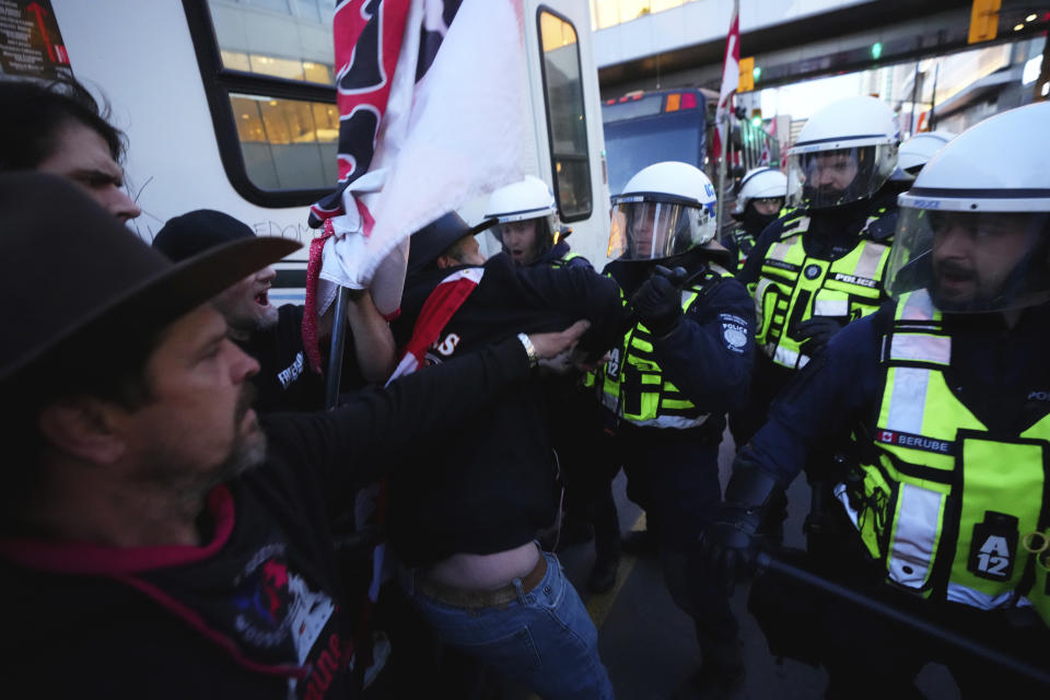 Protesters confront police during a demonstration, part of a convoy-style protest participants are calling "Rolling Thunder," in Ottawa, Ontario, Friday, April 29, 2022. (Sean Kilpatrick/The Canadian Press via AP)