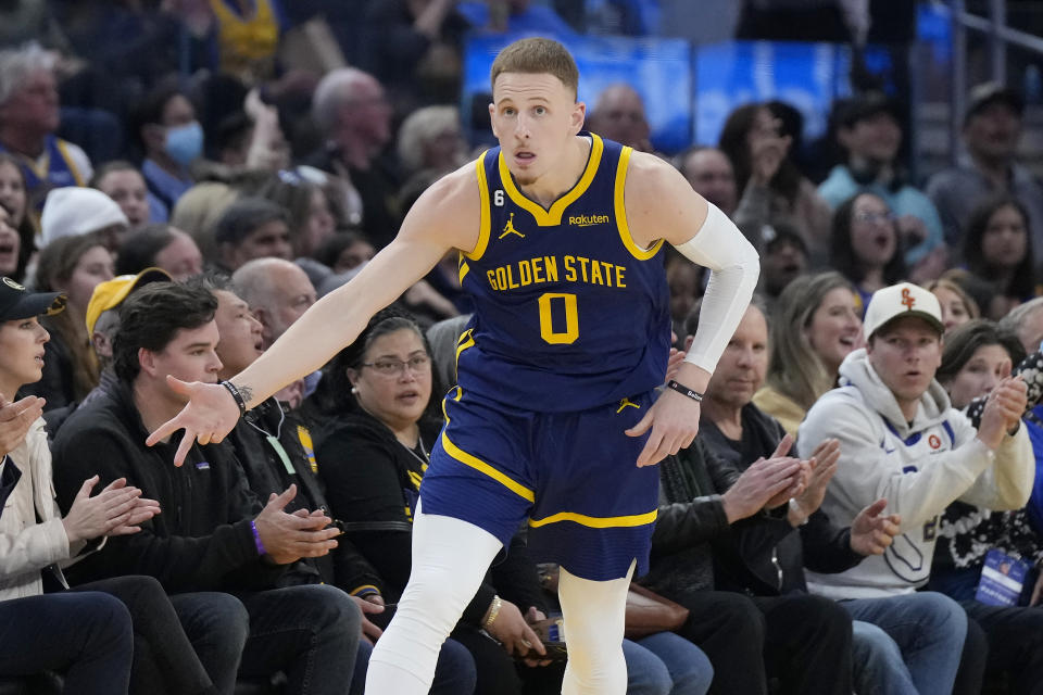 Golden State Warriors guard Donte DiVincenzo (0) gestures after making a 3-point basket during the first half of an NBA basketball game against the Minnesota Timberwolves in San Francisco, Sunday, Feb. 26, 2023. (AP Photo/Jeff Chiu)