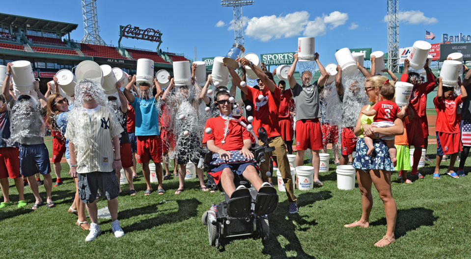 Red Sox players and staff participate in the Ice Bucket Challenge at Fenway Park, with co-founders Pete Frates, center, and Pat Quinn, left, on July 31, 2015. Frates died in 2019 and Quinn in 2020, of ALS. / Credit: Arthur Pollock/MediaNews Group/Boston Herald via Getty Images