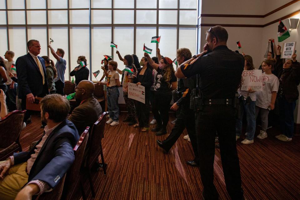 Florida State University Students for a Democratic Society and other organizations attend an FSU Board of Trustees meeting where they waived Palestinian flags and chanted before being escorted out by the FSU Police Department on Friday, Nov. 10, 2023.