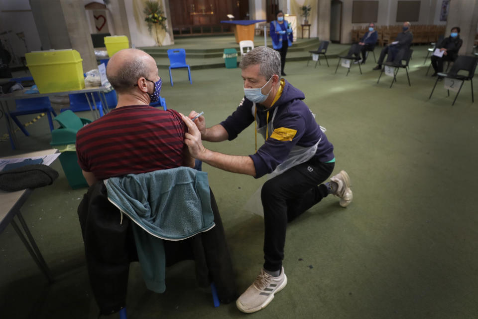 Nick Gray, a St Johns Ambulance vaccinator gives the AstraZeneca vaccine at St John's Church, in Ealing, London, Tuesday, March 16, 2021. In recent days, countries including Denmark, Ireland and Thailand have temporarily suspended their use of AstraZeneca's coronavirus vaccine after reports that some people who got a dose developed blood clots, even though there's no evidence that the shot was responsible. The European Medicines Agency and the World Health Organization say the data available do not suggest the vaccine caused the clots.​ Britain and several other countries have stuck with the vaccine. (AP Photo/Kirsty Wigglesworth)