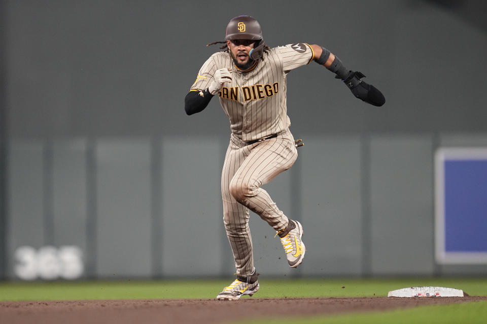 San Diego Padres' Fernando Tatis Jr. advances to third base after a throwing error by Minnesota Twins catcher Christian Vazquez during the seventh inning of a baseball game Tuesday, May 9, 2023, in Minneapolis. (AP Photo/Abbie Parr)